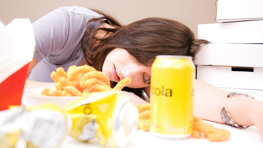 Woman sleeping after eating a lot of food